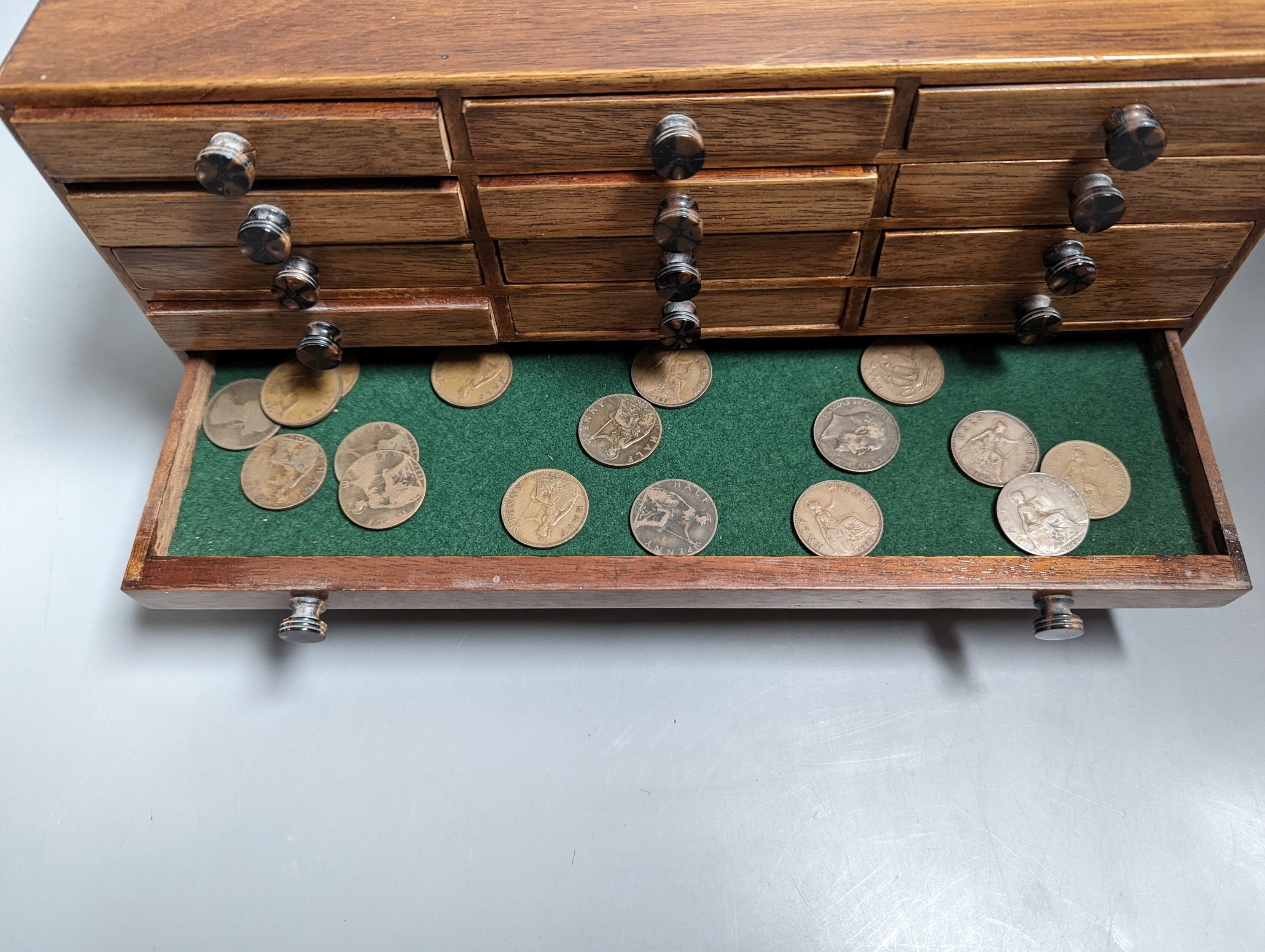 A collection of coins Victoria to Elizabeth II, together with a small coin cabinet and various reference books
